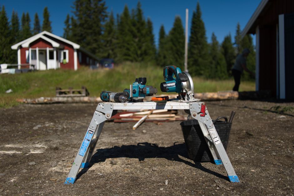 Outdoor setup with power tools for construction work in a summer setting.