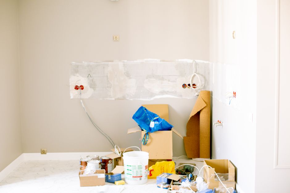 A room undergoing renovation with tools, supplies, wiring
